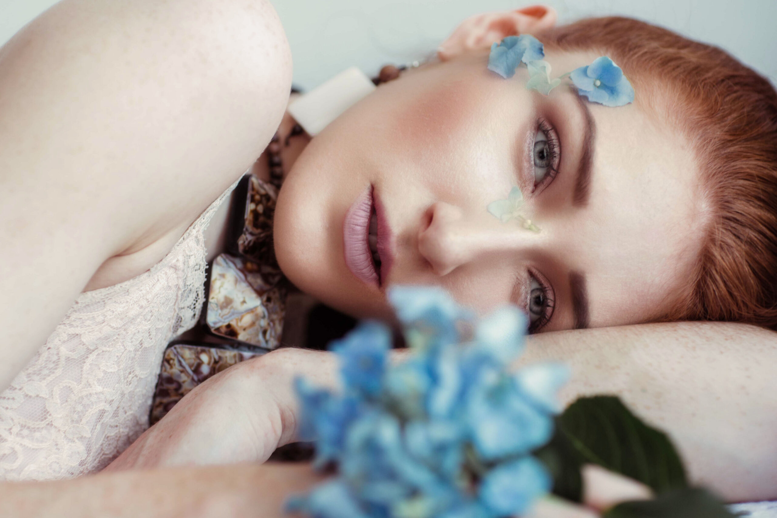 Lady laying down with hydrangeas