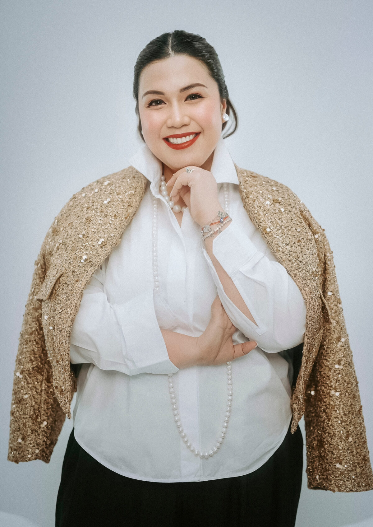 woman in gold blazer red lipstick 