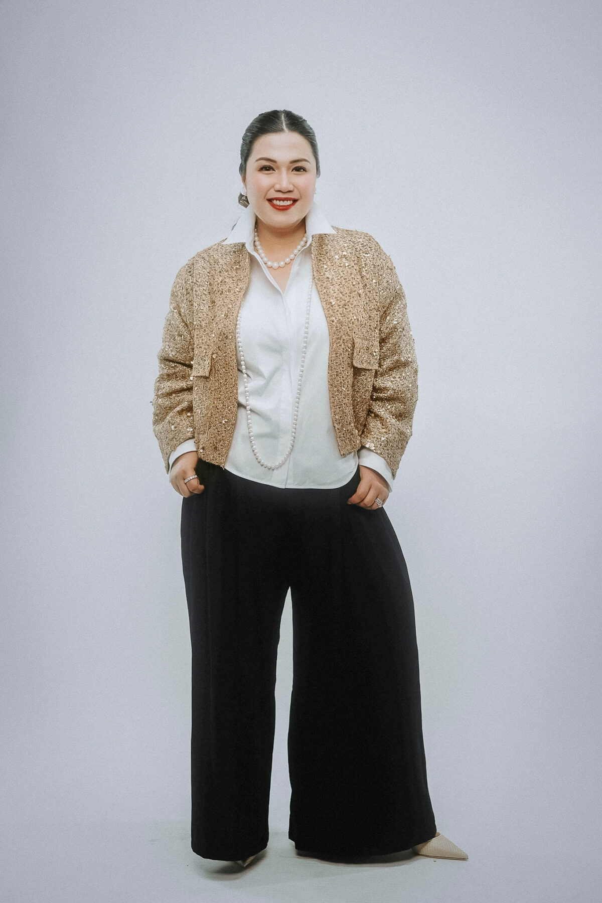 woman in gold blazer red lipstick 