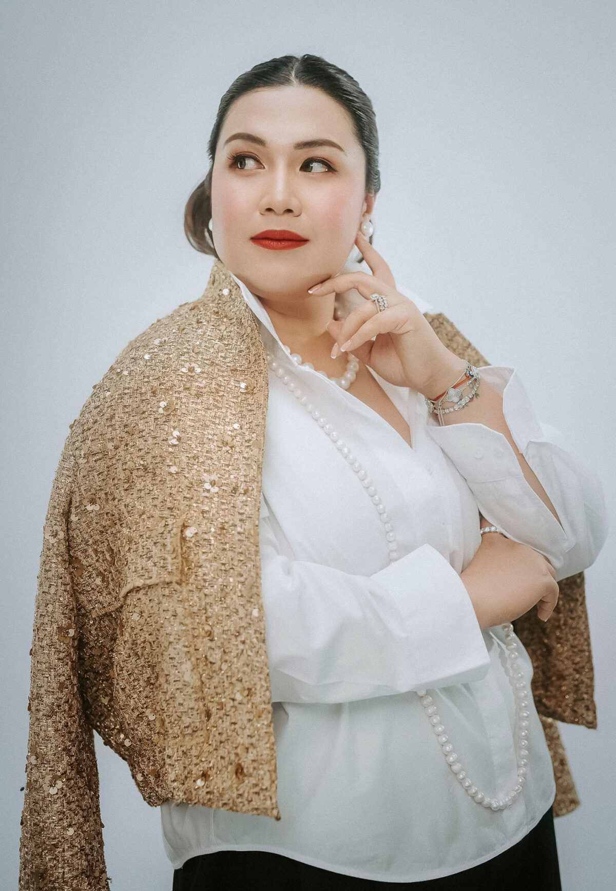 woman in gold blazer red lipstick 