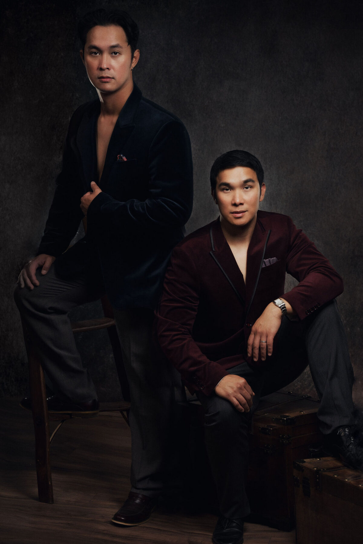 two men in leather a suede burgundy suit dressed for vanity fair 
