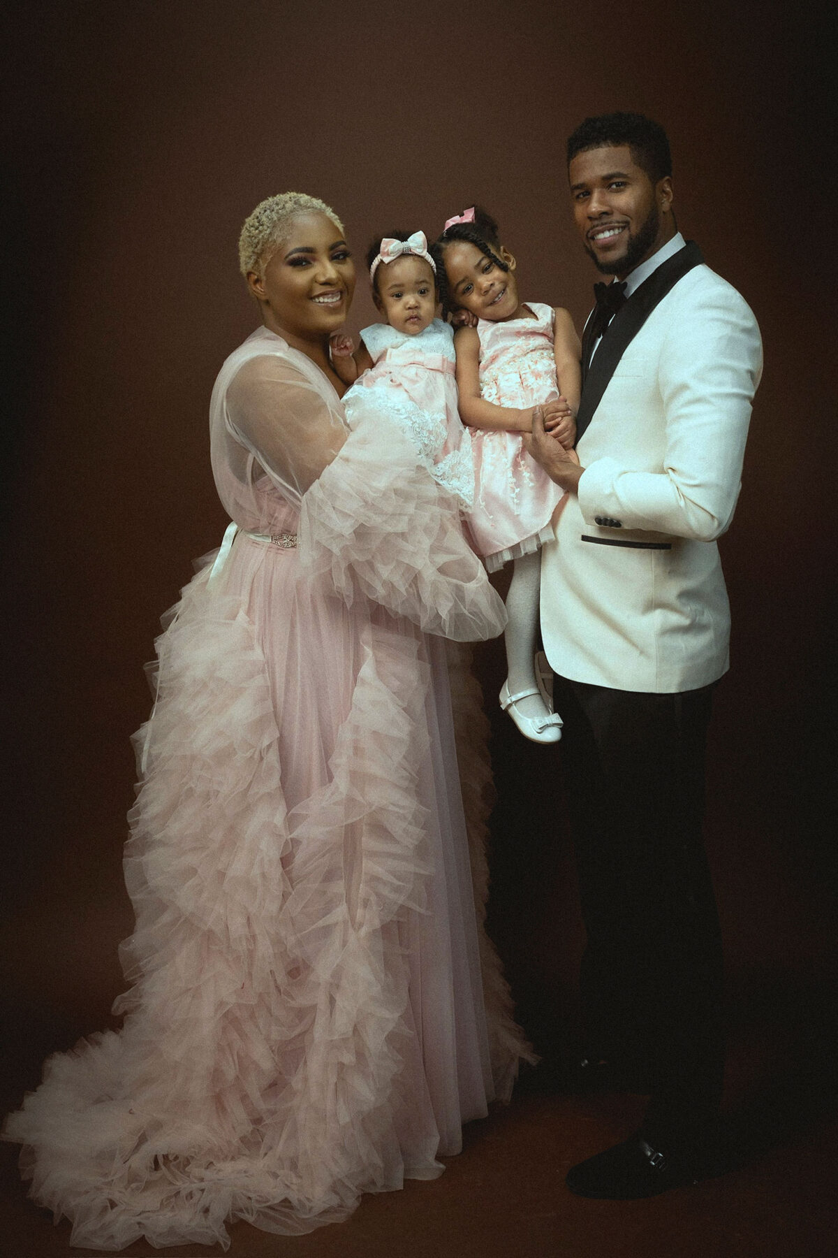 a family wearing formal outfit in the studio