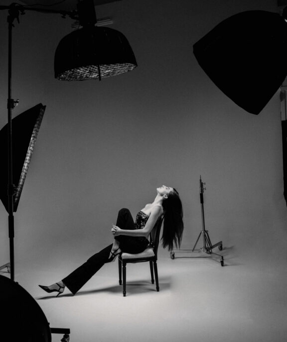 A lady inside a studio cyclorama with lighting set up and editorial vibe