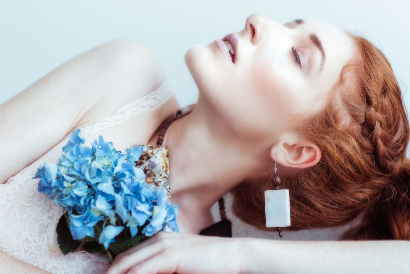 red haired Woman shot editorial with hydrangeas